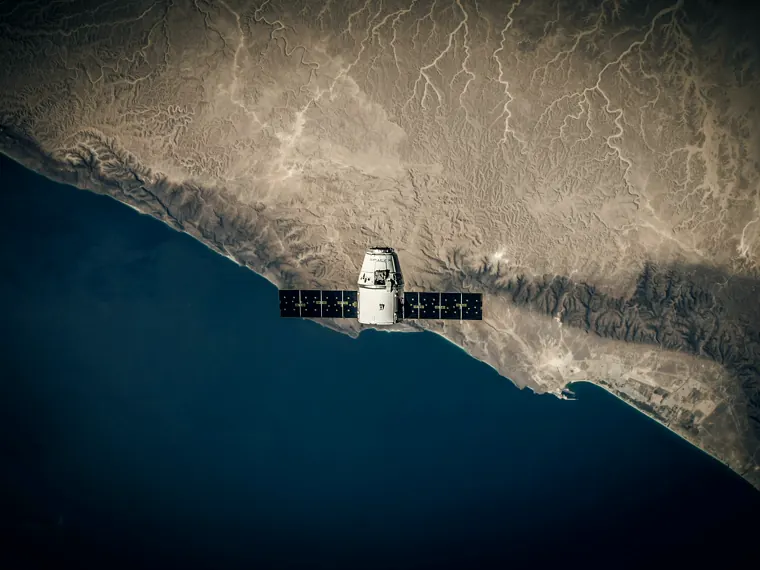 A satellite above a desert coastline.