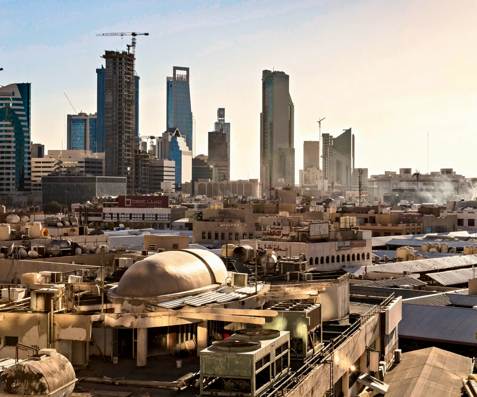 The Riyadh skyline at dusk, new towers rising behind the older city.
